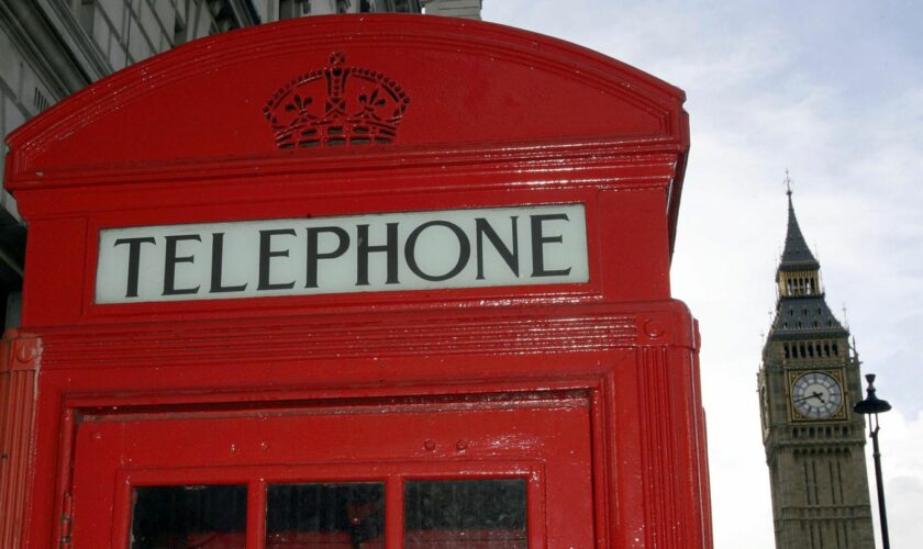 Eine rote Telefonzelle steht vor dem Big Ben in London