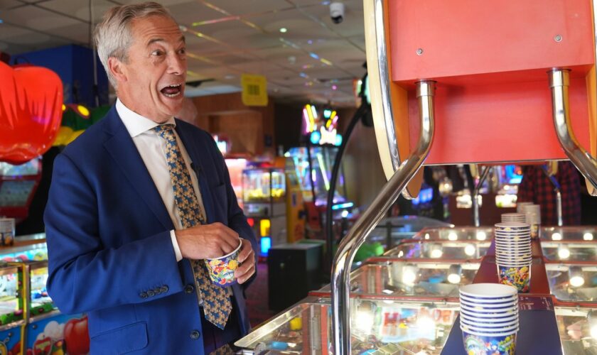 Reform UK leader Nigel Farage playing a 2p machine in Clacton-on-Sea, Essex, while on the General Election campaign trail. Picture date: Friday June 21, 2024.