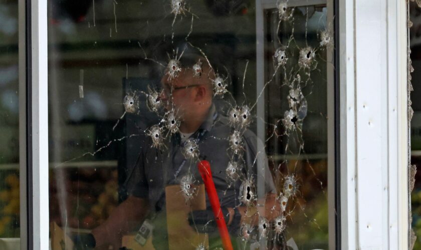 Damage to the supermarket's front window after the shooting. Pic: AP