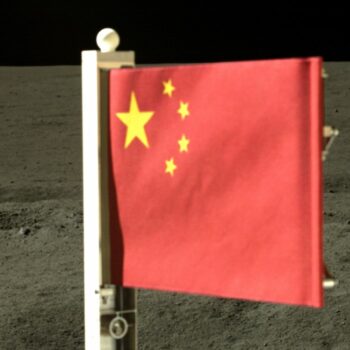 In this China National Space Administration (CNSA) handout image released by Xinhua News Agency, a Chinese national flag carried by the lander of Chang'e-6 probe unfurls at the moon's far side, Tuesday, June 4, 2024. China says a spacecraft carrying rock and soil samples from the far side of the moon has lifted off from the lunar surface to start its journey back to Earth. (CNSA/Xinhua via AP)