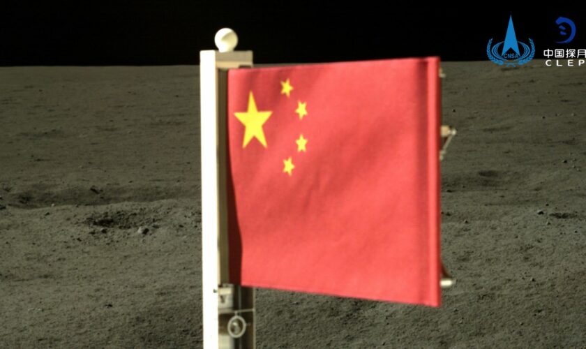 In this China National Space Administration (CNSA) handout image released by Xinhua News Agency, a Chinese national flag carried by the lander of Chang'e-6 probe unfurls at the moon's far side, Tuesday, June 4, 2024. China says a spacecraft carrying rock and soil samples from the far side of the moon has lifted off from the lunar surface to start its journey back to Earth. (CNSA/Xinhua via AP)