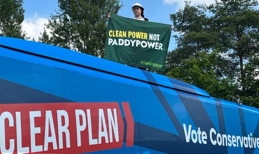 Amy Rugg-Easey on top of the Conservative election campaign bus in Nottinghamshire on Wednesday. Pic: PA