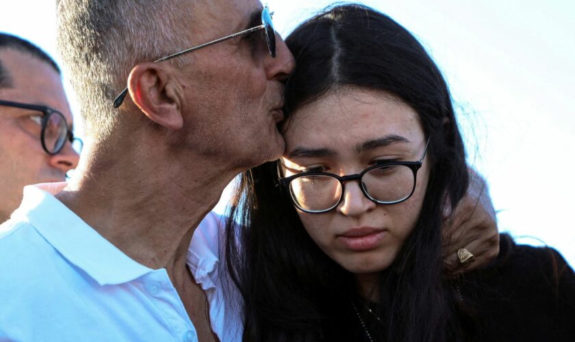 Noa and her father during the funeral in Beersheba. Pic: Reuters