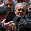 Reformist candidate for the Iran's presidential election Masoud Pezeshkian is greeted by his supporters as he arrives to vote at a polling station in Shahr-e-Qods near Tehran, Iran, Friday, July 5, 2024. Iranians are voting in a runoff election to replace the late President Ebrahim Raisi, who was killed in a May helicopter crash in the country...s northwest along with the foreign minister and several other officials. (AP Photo/Vahid Salemi)