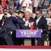 Secret service rush bloodied Trump off stage as ex-president fist pumps towards enraged crowd shouting 'USA, USA'