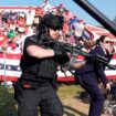 Secret Service agents rush the stage. Pic: AP