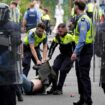 Officers detain a protester after violence at the former site of the Crown Paints factory in Coolock, north Dublin. Pic: PA