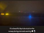 Hair-raising moment terror-stricken passengers are 'trapped' in 'shaking' aircraft being 'blown back and forth' on the runway after Chicago airport is evacuated amid tornado warning