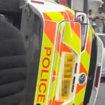 Police car flipped on to its side as unrest breaks out in Leeds