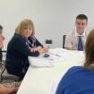 Wales's education secretary Lynne Neagle speaks with pupils at Whitmore High School in the Vale of Glamorgan