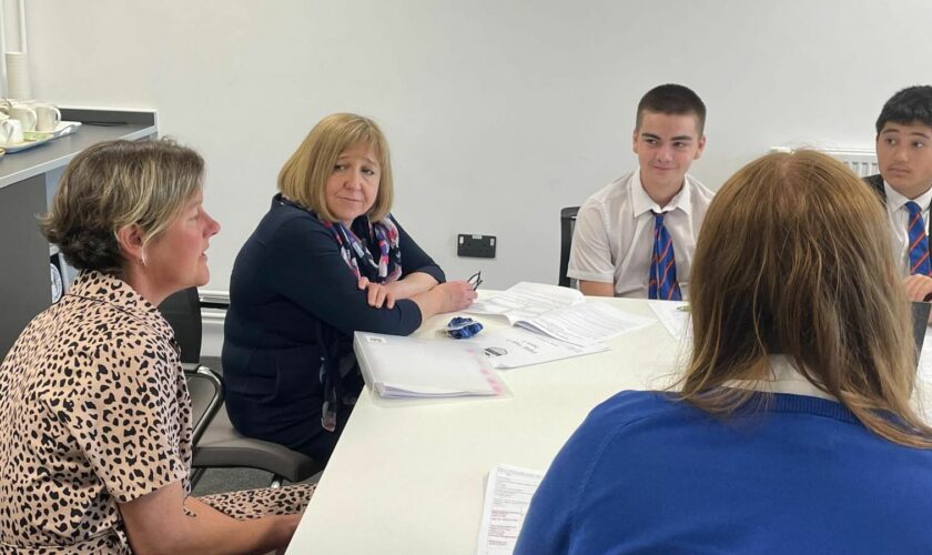 Wales's education secretary Lynne Neagle speaks with pupils at Whitmore High School in the Vale of Glamorgan