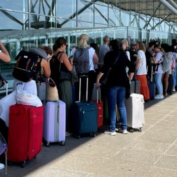 Passengers queue outside Stansted Airport amid the global outage. Pic: PA