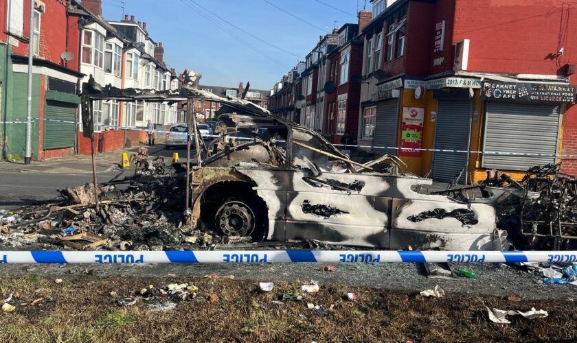 Vehicles were set on fire and a police car was overturned. Pic: PA