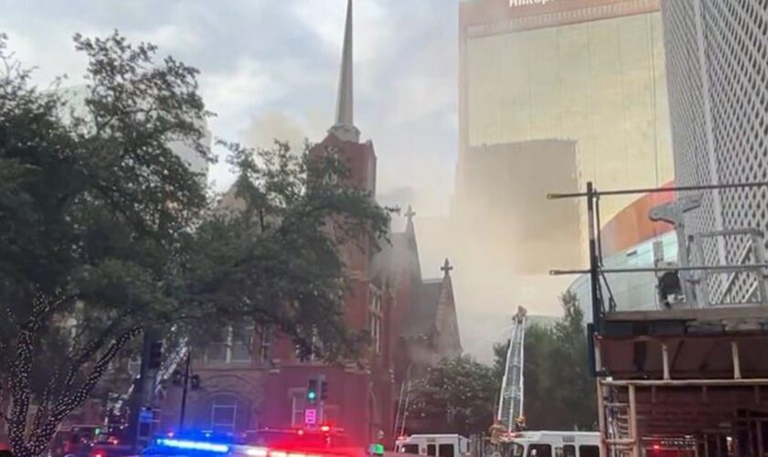 Smoke rises above the historic First Baptist Church in downtown Dallas