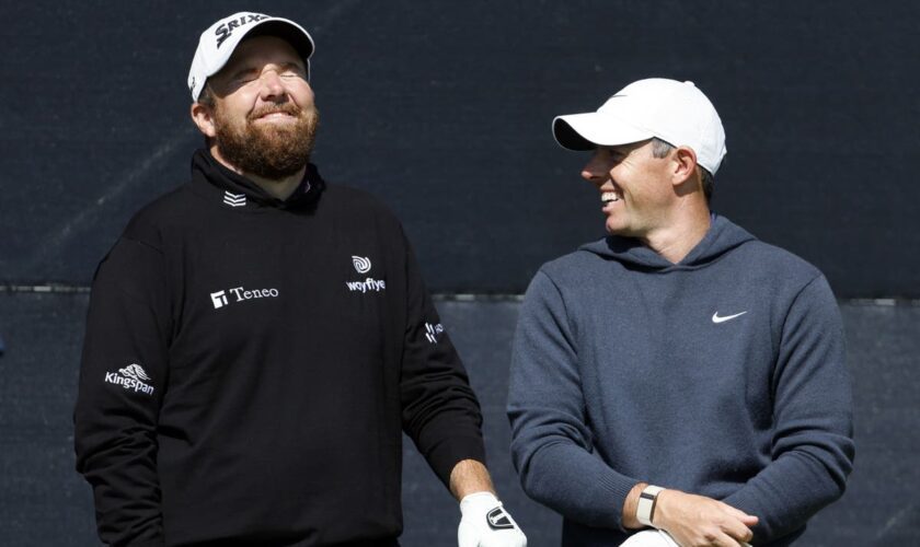 Open day three: Rory McIlroy supporting leader Shane Lowry after missing the cut