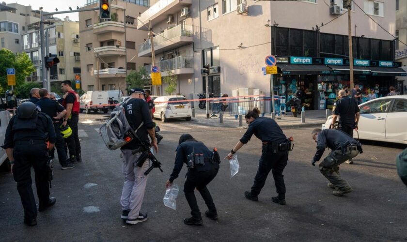 Israeli police investigate the scene of an explosive drone attack in Tel Aviv. Pic: AP