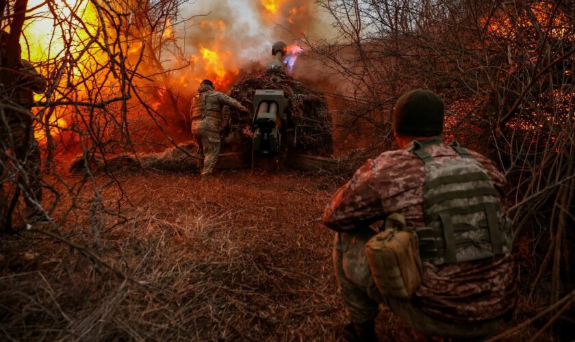 Ukrainian servicemen fire a D-30 howitzer towards Russian troops in Kherson. Pic: Reuters