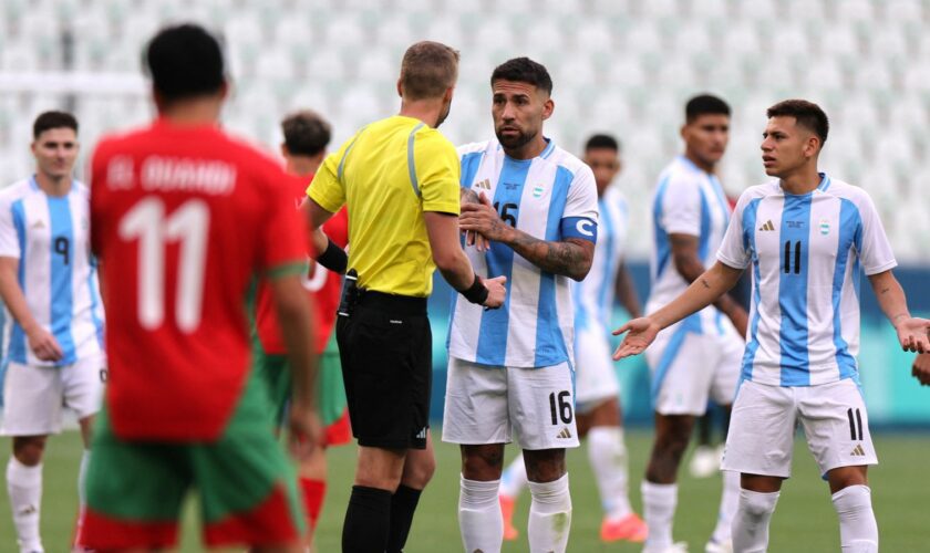 Referee Glenn Nyberg talks to Argentina's Nicolas Otamendi. Pic: Reuters