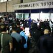 Crowd of hundreds mass overnight outside police station where men from Manchester Airport video were taken after chaotic incident where cop kicked and stamped on man's head chanting 'GMP shame on you'