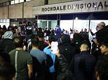 Crowd of hundreds mass overnight outside police station where men from Manchester Airport video were taken after chaotic incident where cop kicked and stamped on man's head chanting 'GMP shame on you'