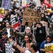 Crowds of protesters block roads and trams in Manchester city centre branding police 'racist' and calling for cops to be sacked over airport 'kicking and stamping' attack - as watchdog opens second probe and sets up witness hotline