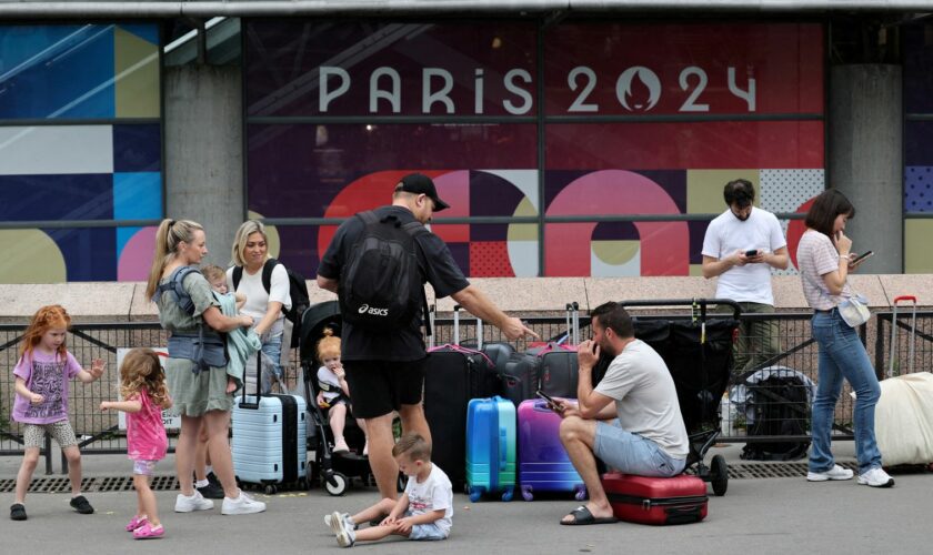 Travellers from Sydney, Australia, wait outside the Gare Montparnasse train station as they try to search for other trains after their trip was affected when vandals targeted France's high-speed train network with a series of coordinated actions that brought major disruption, ahead of the Paris 2024 Olympics opening ceremony, in Paris, France, July 26, 2024. REUTERS/Maye-E Wong TPX IMAGES OF THE DAY