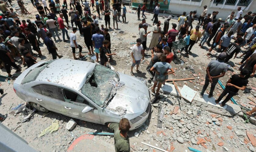 Palestinians inspect a school sheltering displaced people following an Israeli strike in Deir al Balah in central Gaza. Pic: Reuters