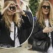 Celine Dion thanks fans for the love and support as she throws up a heart sign with her hands in Paris after her emotional Olympic comeback performance amid battle with SPS