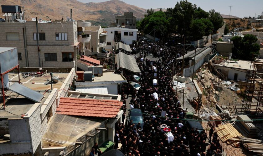 Coffins are carried through the streets of Majdal Shams in Golan Heights. Pic: Reuters