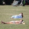 Britain bakes: Brits take a dip in the sea and sunbathe in parks as heatwave grips the UK - with temperatures set to eclipse hottest day of the year so far