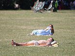 Britain bakes: Brits take a dip in the sea and sunbathe in parks as heatwave grips the UK - with temperatures set to eclipse hottest day of the year so far