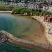 People enjoy the sunshine at Cullercoats Bay on North Tyneside. Pic: PA