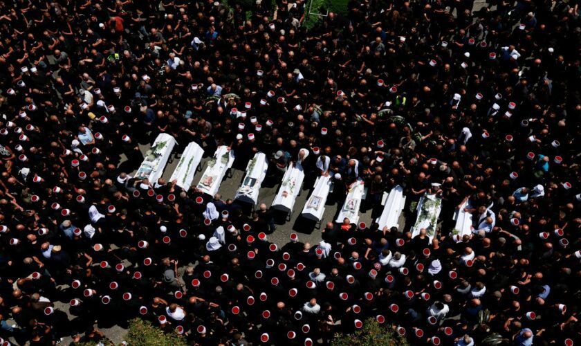 People gather for the funeral of children who were killed at the football pitch in Majdal Shams. Pic: Reuters