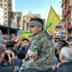 A child on a man's shoulders at a Hezbollah funeral in Beirut, Lebanon