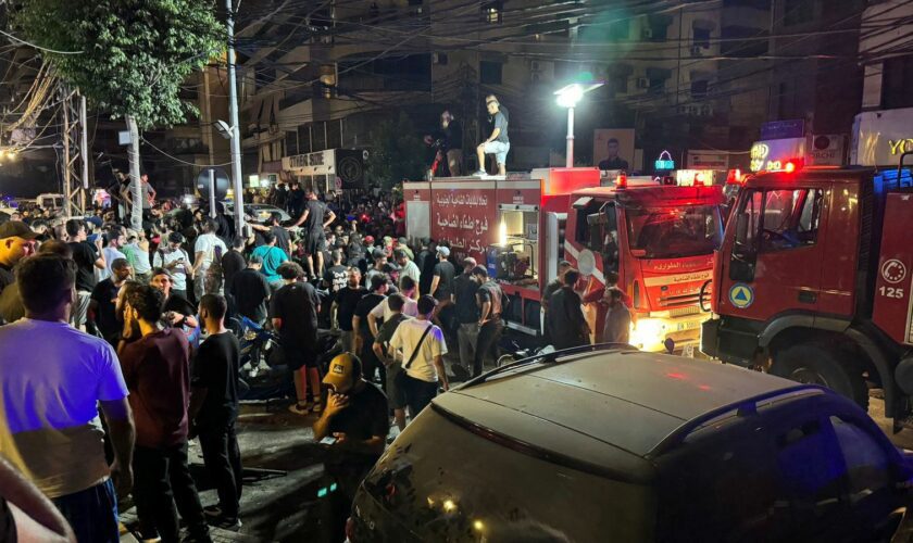 People gather near a site hit by what security sources said was a strike on Beirut's southern suburbs, Lebanon July 30, 2024. REUTERS/Mohamed Azakir