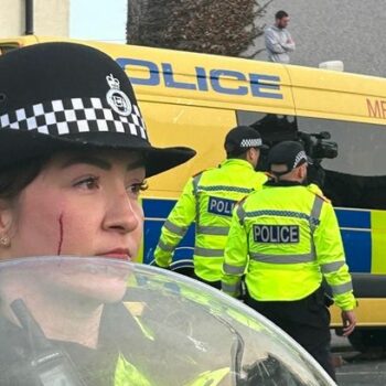 Powerful photo shows female officer with blood dripping down face at violent Southport riot