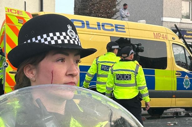 Powerful photo shows female officer with blood dripping down face at violent Southport riot