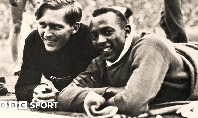 Luz Long and Jesse Owens pose at the side of the track at the 1936 Olympics in Berlin