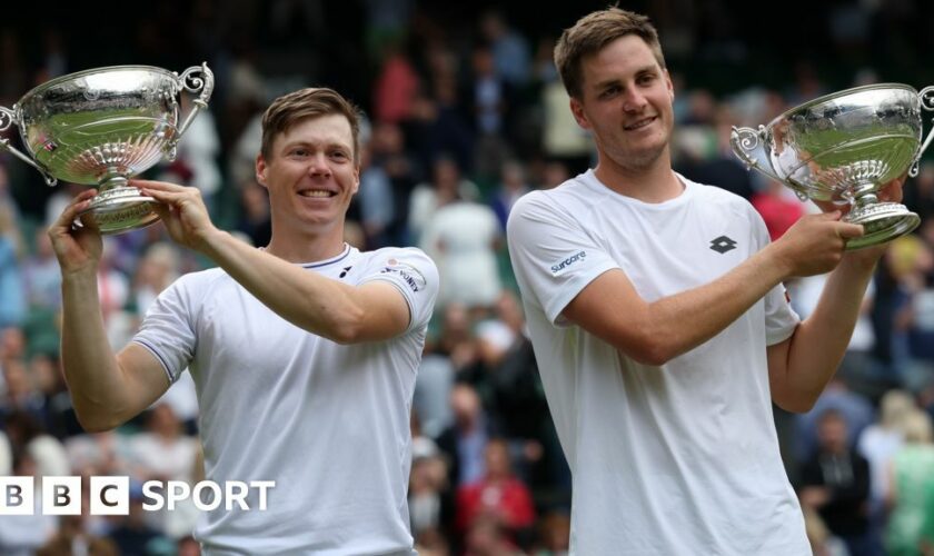 Harri Heliovaara and Henry Patten hold their Wimbledon doubles trophies