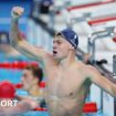 Leon Marchand celebrates winning gold