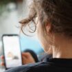 ILLUSTRATION - 28 September 2023, Berlin: A woman lies on a sofa and watches a video on the social media platform Instagram on her cell phone. (to dpa "#therapy: Pseudopsychology in social media and its consequences") Photo by: Weronika Peneshko/picture-alliance/dpa/AP Images