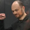 Vladimir Kara-Murza gestures standing in a glass cage in a courtroom during announcement of the verdict on appeal at the Moscow City Court in Moscow, Russia, on July 31, 2023.