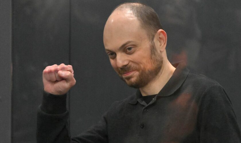 Vladimir Kara-Murza gestures standing in a glass cage in a courtroom during announcement of the verdict on appeal at the Moscow City Court in Moscow, Russia, on July 31, 2023.