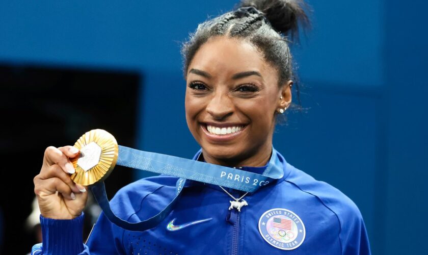 Simone Biles shows off her gold medal. Pic: Pete Dovgan/Speed Media/Icon Sportswire/AP