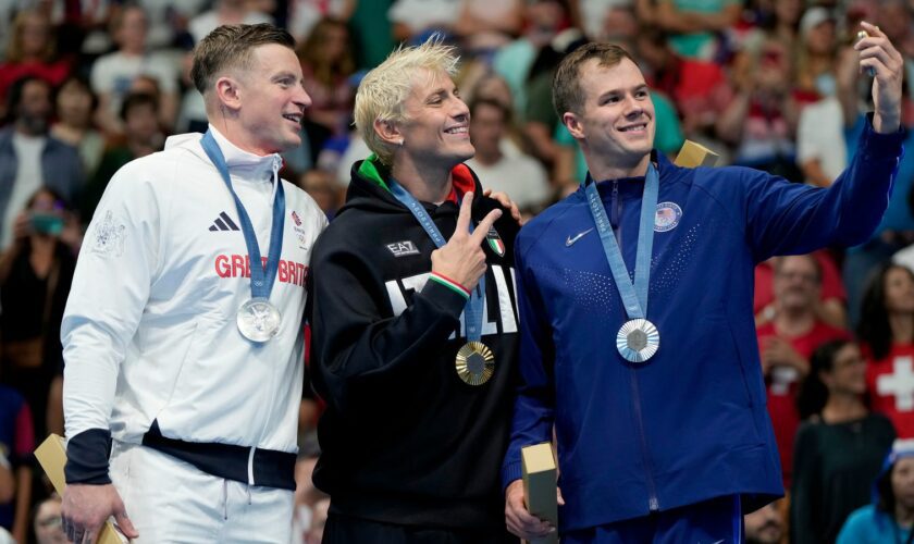 Italian gold medalist Nicolo Martinenghi takes a victory selfie with dual silver medalists Team GB's Adam Peaty, and Nic Fink of the the United States. Pic: AP