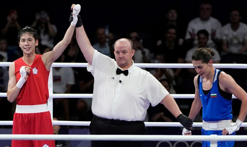 Taiwan's Lin Yu-ting celebrates after defeating Bulgaria's Svetlana Staneva in their women's 57 kg quarterfinal boxing match at the 2024 Summer Olympics, Sunday, Aug. 4, 2024, in Paris, France. (AP Photo/John Locher)