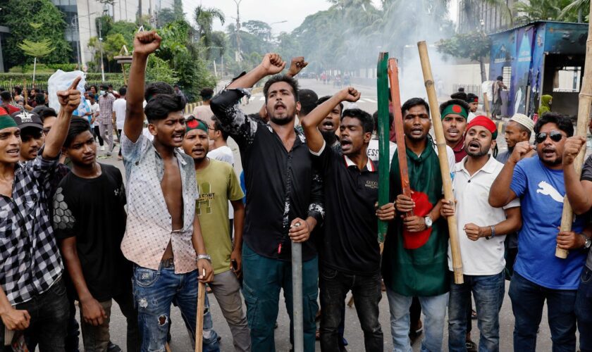 Demonstrators shout slogans after they have occupied a street in Dhaka. Pic: Reuters