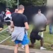 Black man kicked and punched by mob throwing fences in shocking riot footage