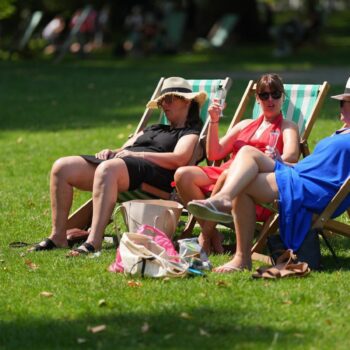 People enjoy the warm weather in St James' Park, London. Picture date: Friday August 2, 2024.