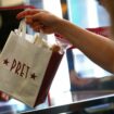 A bag is passed to a customer at Pret a Manger in New Cavendish Street, following the outbreak of the coronavirus disease (COVID-19), London, Britain, June 1, 2020. REUTERS/Hannah McKay